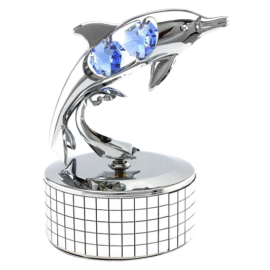 Decorative sculpture of a dolphin with blue gemstones on a white background